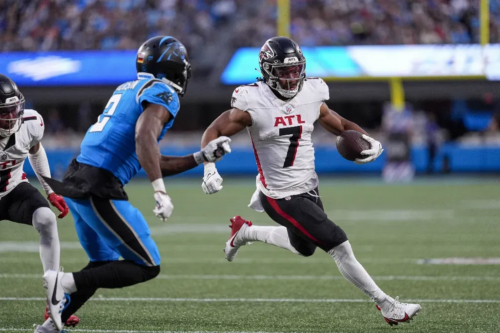 Oct 13, 2024; Charlotte, North Carolina, USA;Carolina Panthers cornerback Michael Jackson (2) looks to cut off Atlanta Falcons running back Bijan Robinson (7) during the second half at Bank of America Stadium. Mandatory Credit: Jim Dedmon-Imagn Images