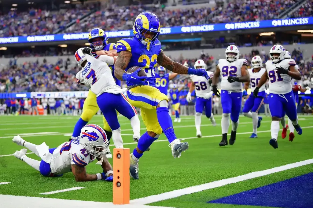 Dec 8, 2024; Inglewood, California, USA; Los Angeles Rams running back Kyren Williams (23) scores a touchdown ahead of Buffalo Bills cornerback Christian Benford (47) during the second half at SoFi Stadium. Mandatory Credit: Gary A. Vasquez-Imagn Images