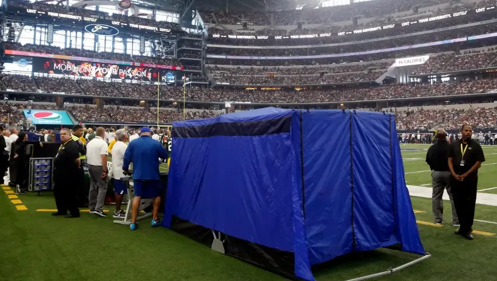 Blue tent - Event photo with crowd in background.