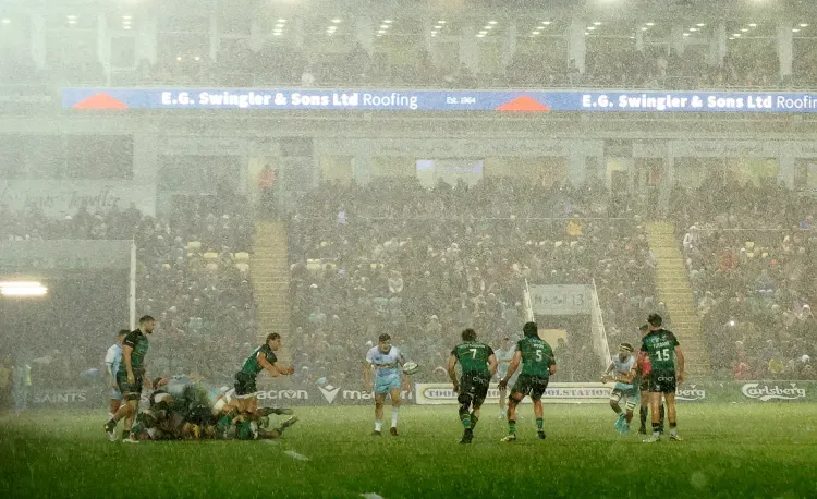 E.G. Swingler - Banner with rugby match in rain.
