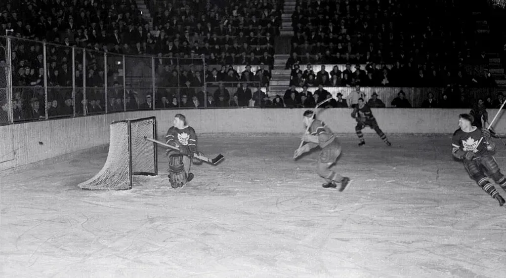Image 62 - Historical hockey photo with players in action.