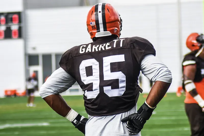 Myles Garrett - Portrait with NFL jersey and helmet.